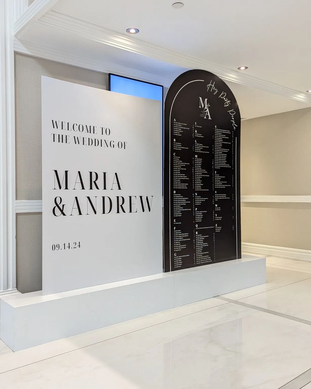 Custom wedding signage and decor installed at a reception.